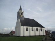 Foto van strand met vuurtoren op Texel